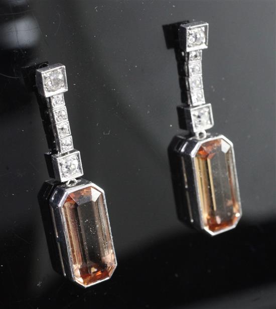 A pair of white gold, pale orange topaz and diamond drop earrings, 1.25in.